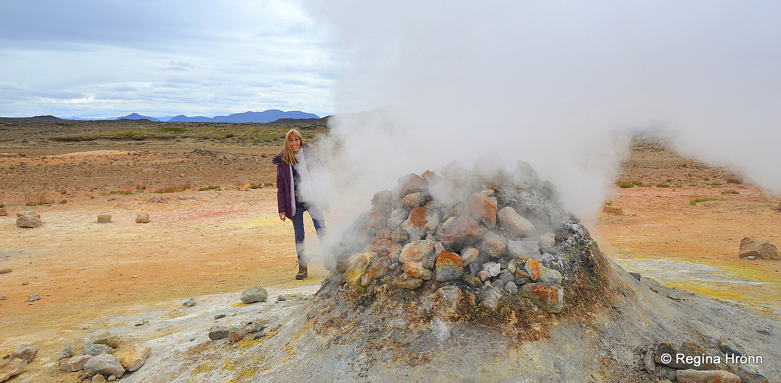 Regína by a hissing borehole at Hverir geothermal area